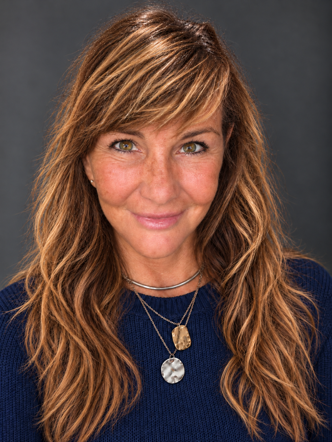 Pepper Humphrey wearing a navy knit sweater, with her hair down