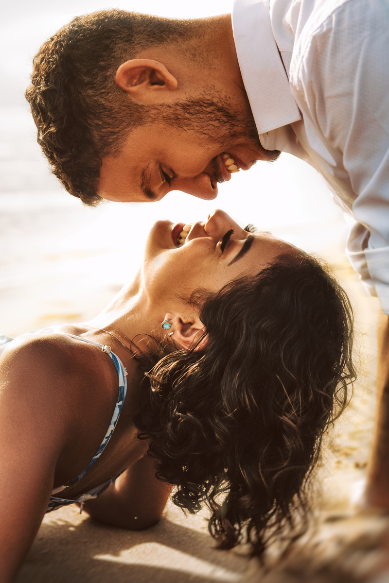Man Kissing Womans Forehead on Beach